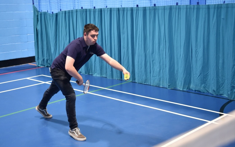 A participant playing badminton