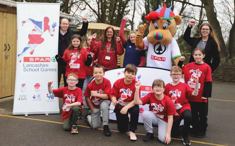 SPAR Lancashire School Games mascot with children from Upholland Roby Mill Primary School