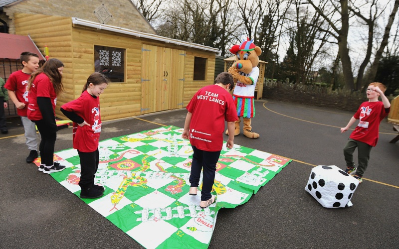SPAR Lancashire School Games mascot with children from Upholland Roby Mill Primary School