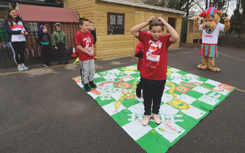 SPAR Lancashire School Games mascot with children from Upholland Roby Mill Primary School