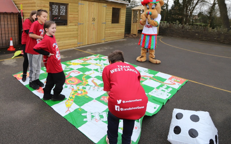 SPAR Lancashire School Games mascot with children from Upholland Roby Mill Primary School