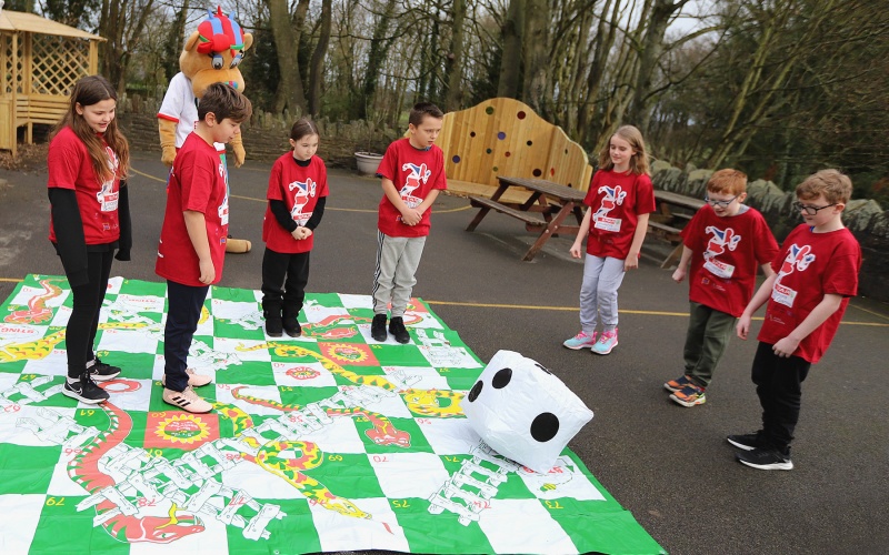 SPAR Lancashire School Games mascot with children from Upholland Roby Mill Primary School