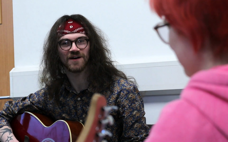 Aaron with an attendee at one of the weekly guitar sessions.